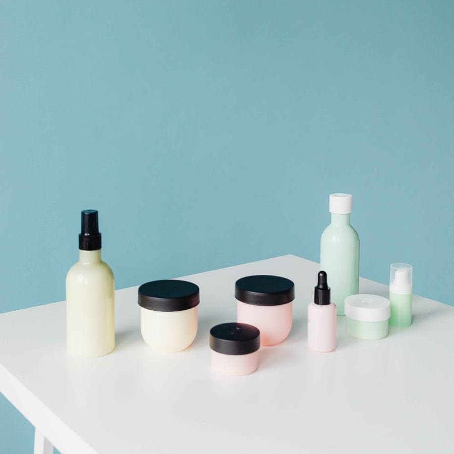 skincare bottles shown against a teal background