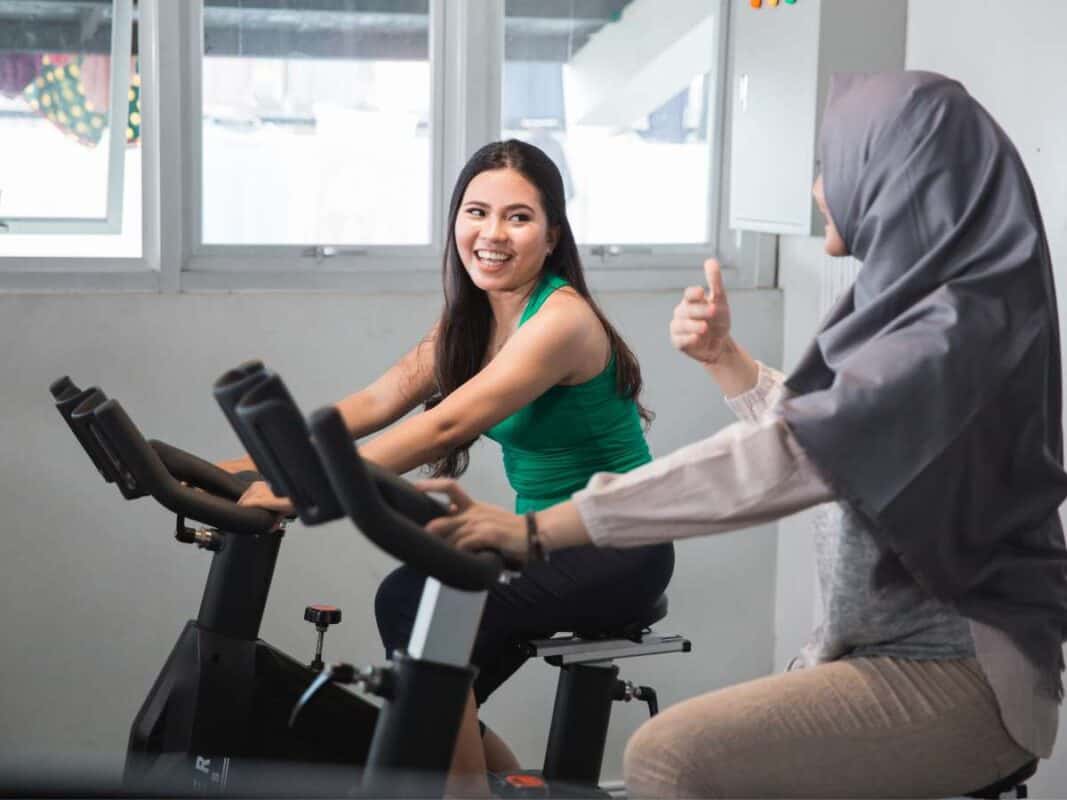 women at the gym on bikes